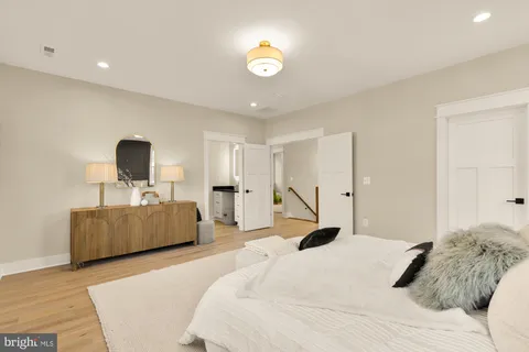 a bedroom with a bed and a mirror