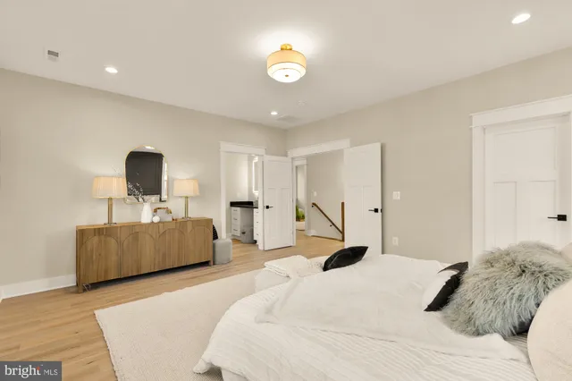 a bedroom with a bed and a mirror