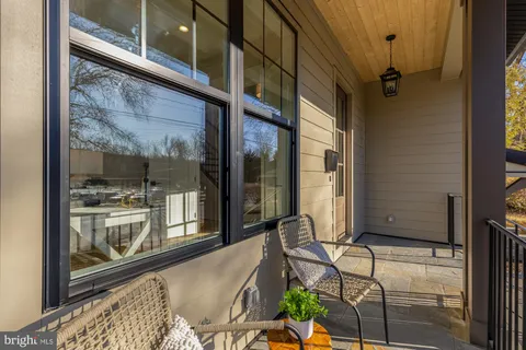 a living room with furniture a window and a potted plant