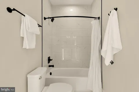 a kitchen with a sink a refrigerator and chairs