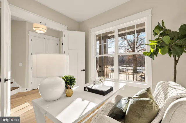 a view of a hallway with wooden floor and entryway