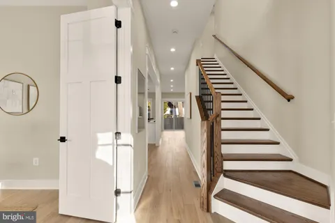 a dining room with furniture a chandelier and wooden floor