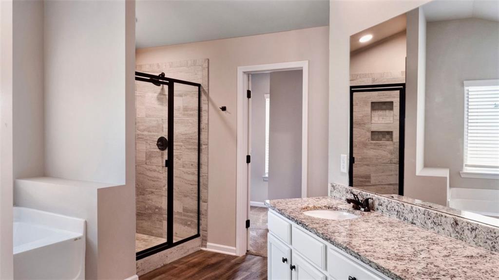 4906 Zoya Court Atlanta, GA 30331 - Photo 18 of 22 a bathroom with a granite countertop sink and a mirror
