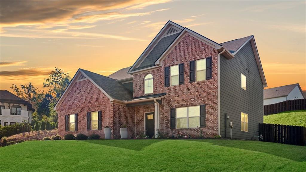 4906 Zoya Court Atlanta, GA 30331 - Photo 21 of 22 a front view of a house with a garden and yard