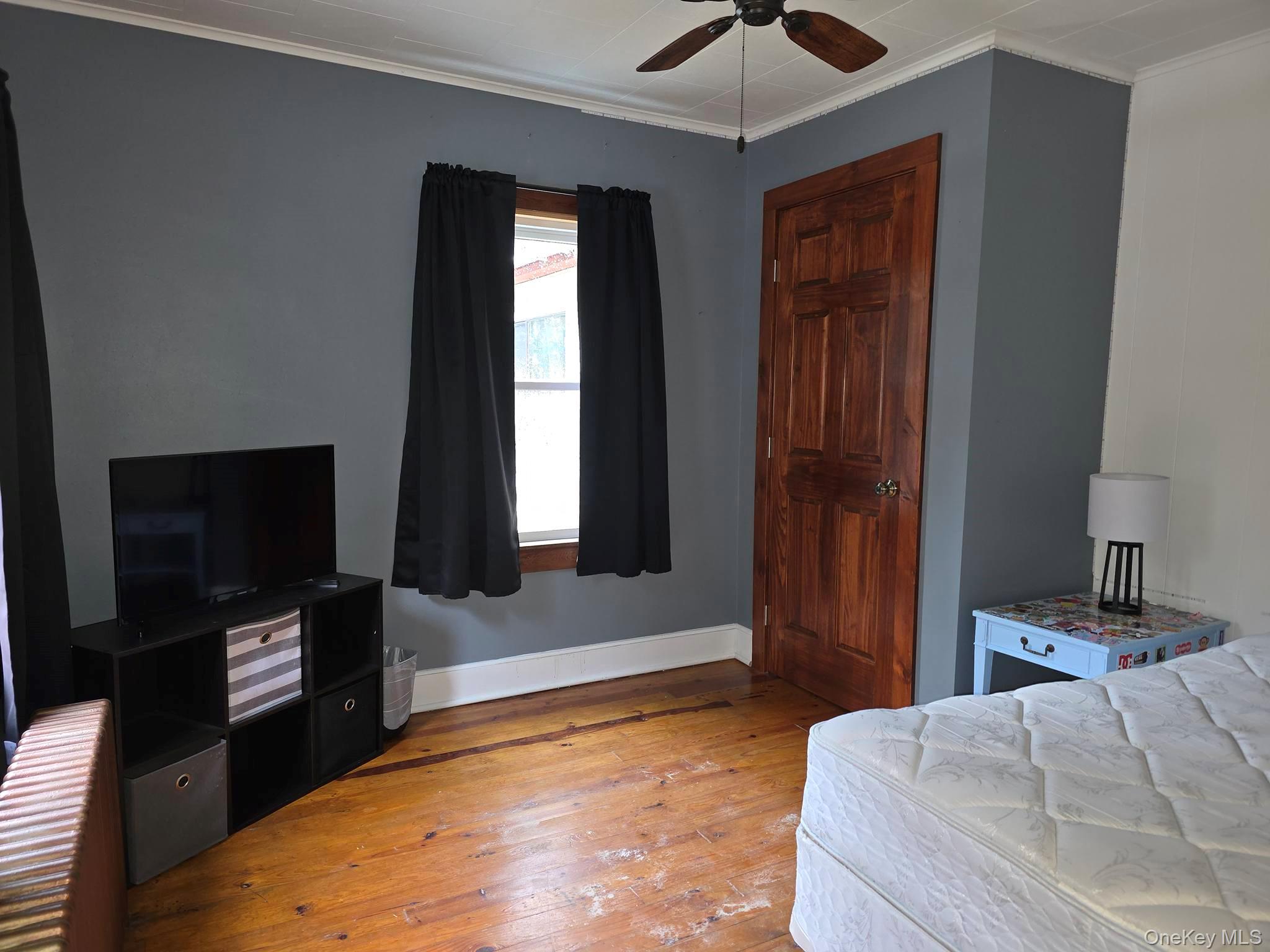 27 Airport Road Eldred, NY 12732 - Photo 12 of 28 a bedroom with a bed and a flat tv screen on a dresser