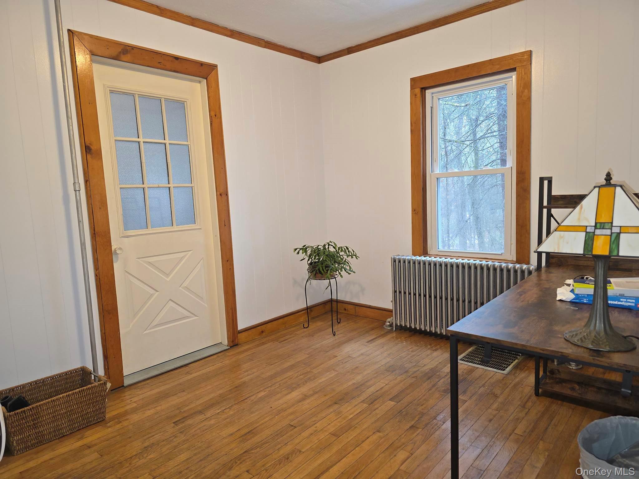 27 Airport Road Eldred, NY 12732 - Photo 14 of 28 an empty room with wooden floor and windows