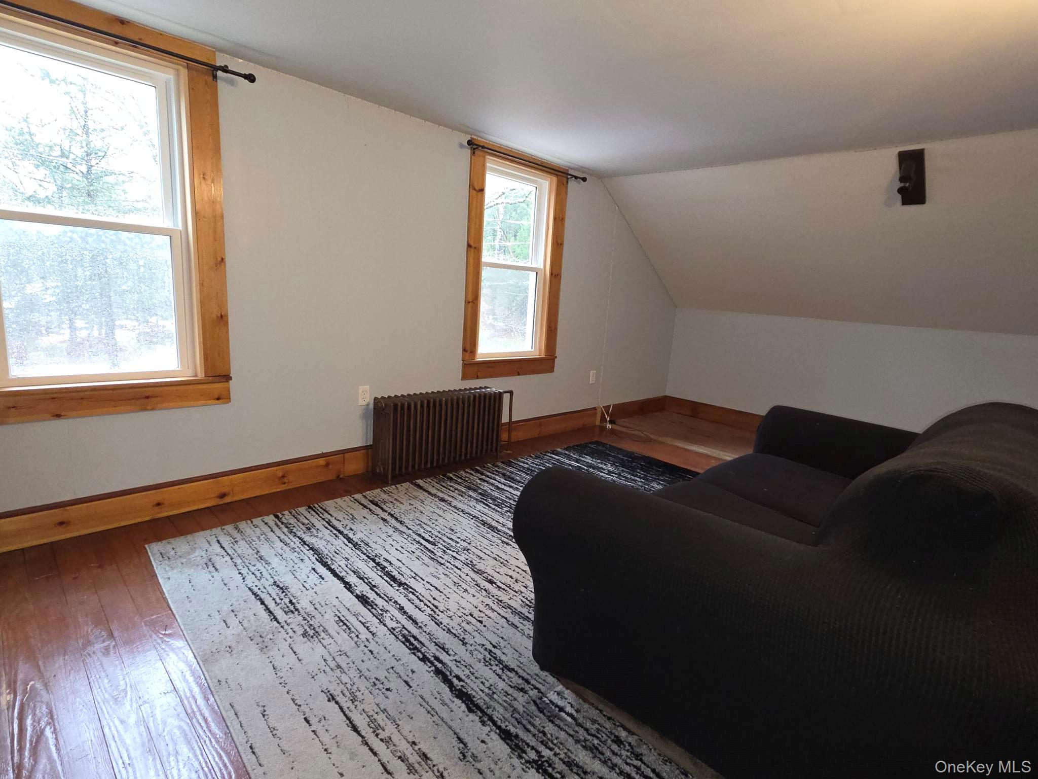 27 Airport Road Eldred, NY 12732 - Photo 20 of 28 a bed sitting in a bedroom next to a window