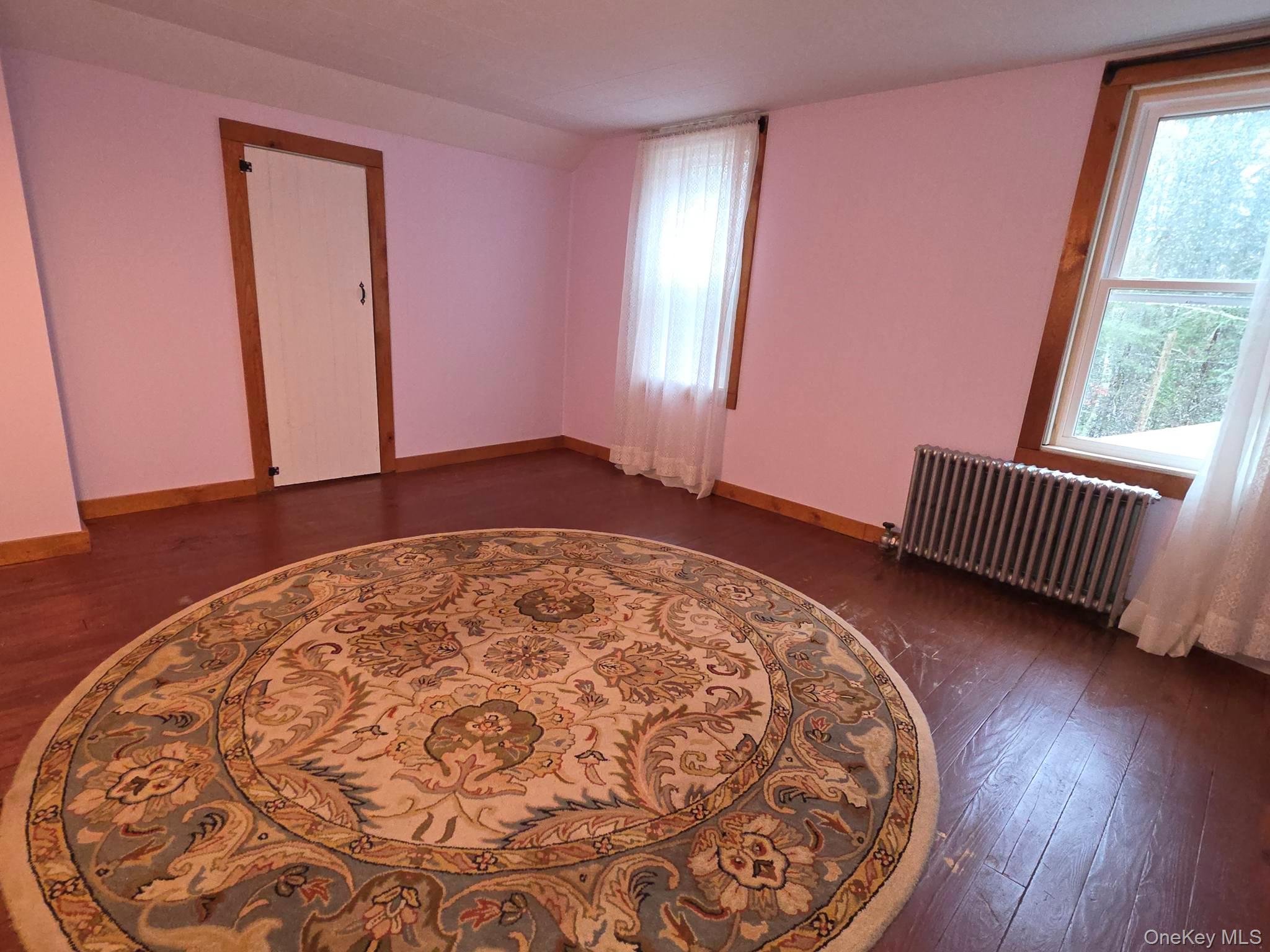 27 Airport Road Eldred, NY 12732 - Photo 22 of 28 an empty room with wooden floor and windows