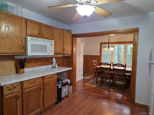 a open kitchen with stainless steel appliances granite countertop a stove and a wooden cabinets