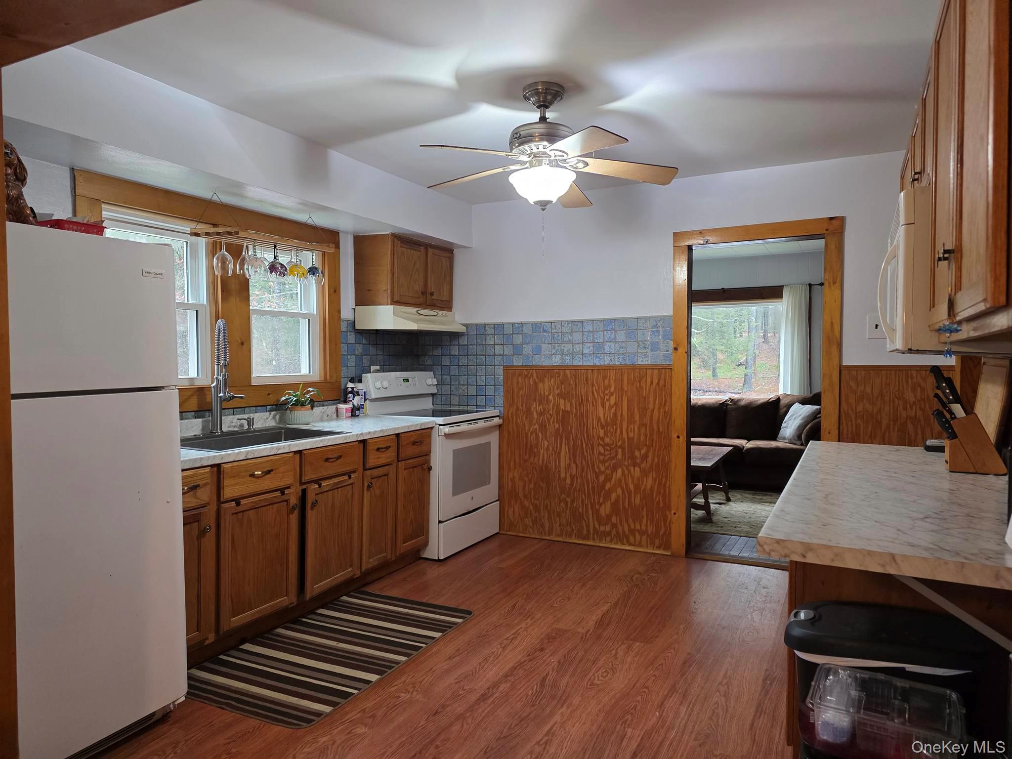 27 Airport Road Eldred, NY 12732 - Photo 10 of 28 a kitchen with stainless steel appliances granite countertop a stove a sink dishwasher and a refrigerator with wooden floor
