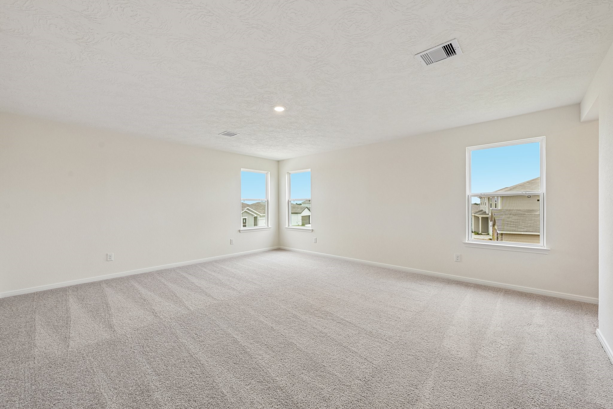 2503 Spruce Hl Road Beasley, TX 77417 - Photo 14 of 25 Relax and recharge in this stunning primary suite! Enjoy the comfort of plush carpeting, neutral-toned walls, high ceilings, recessed lighting, and large windows that fill the room with natural light.
