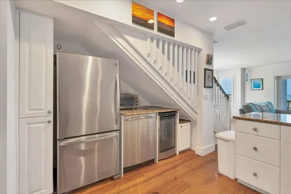a view of hallway with stairs and wooden floor