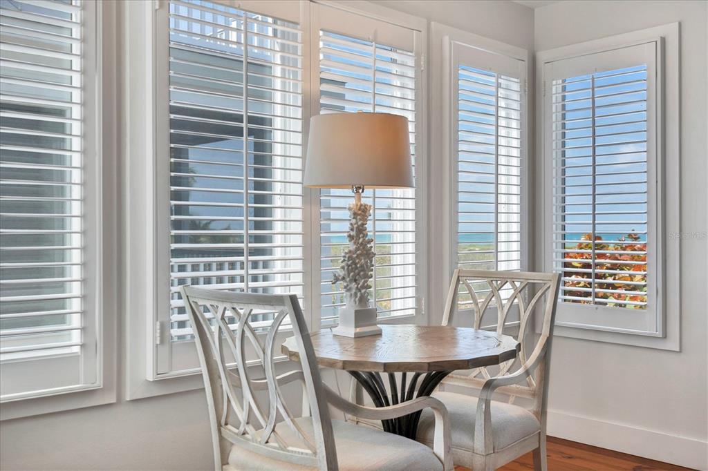 480 Gulf Boulevard, Unit 6 Boca Grande, FL 33921 - Photo 23 of 49 a view of a dining room with furniture and windows
