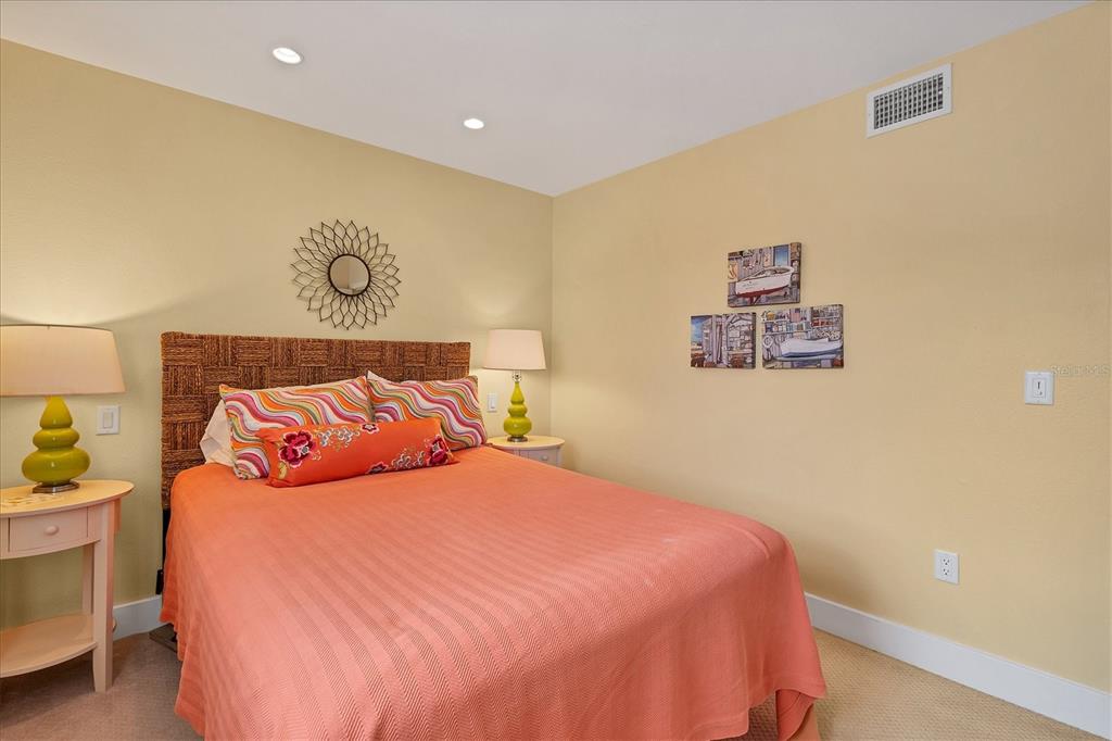 480 Gulf Boulevard, Unit 6 Boca Grande, FL 33921 - Photo 27 of 49 a bedroom with a bed and painting on the wall