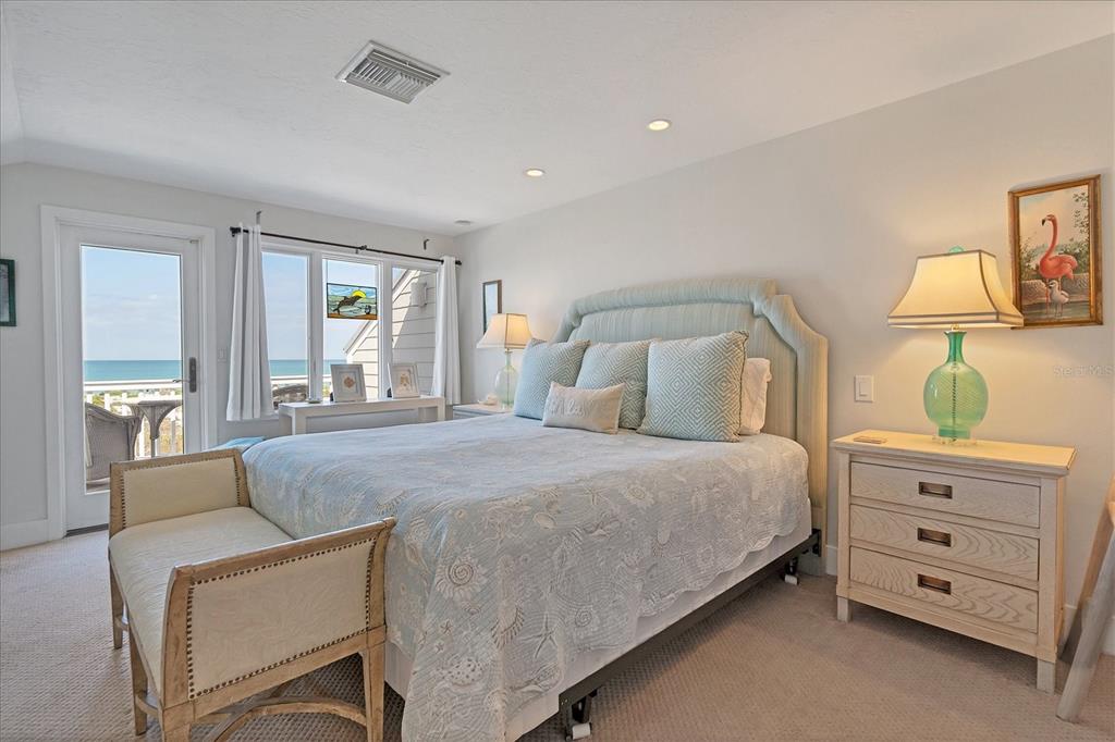 480 Gulf Boulevard, Unit 6 Boca Grande, FL 33921 - Photo 30 of 49 a bedroom with a bed and a couch