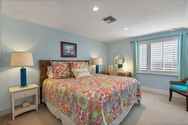 a bedroom with a bed and a lamp on table