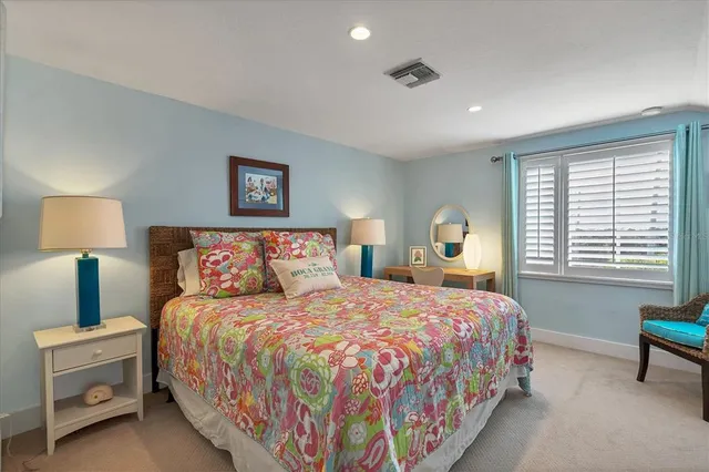 a bedroom with a bed and a lamp on table