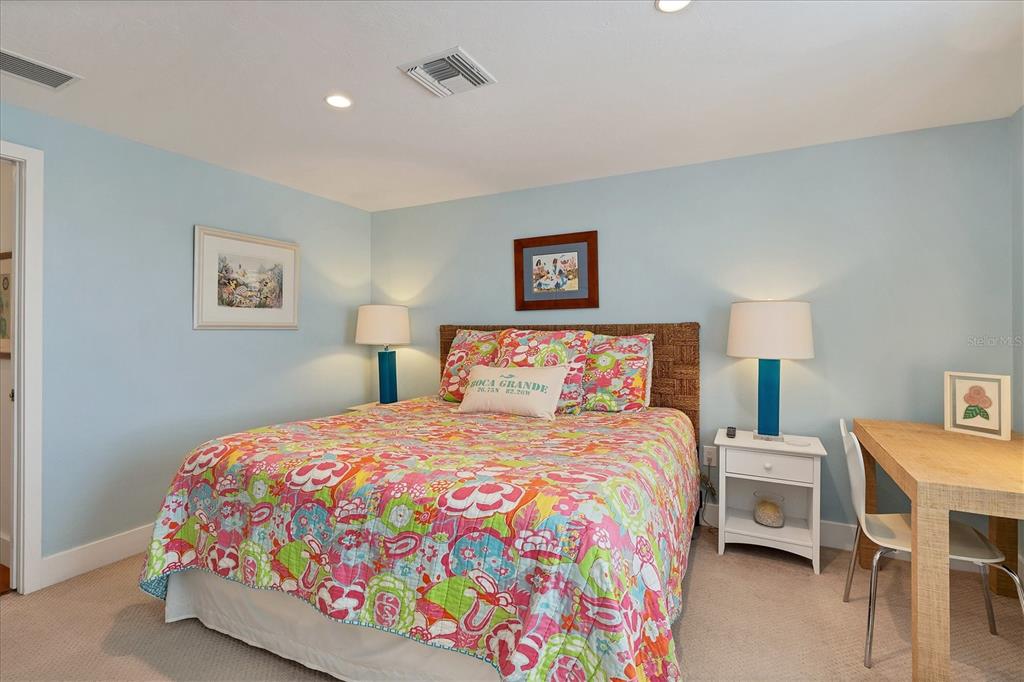 480 Gulf Boulevard, Unit 6 Boca Grande, FL 33921 - Photo 35 of 49 a bedroom with a bed and a lamp on dresser