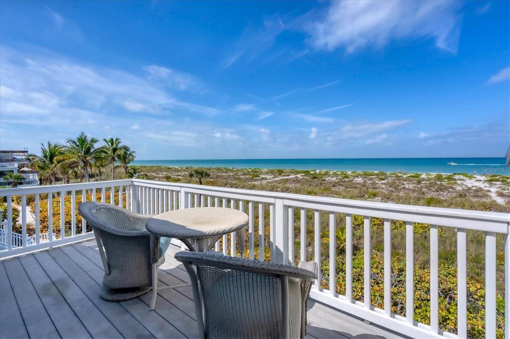 480 Gulf Boulevard, Unit 6 Boca Grande, FL 33921 - Photo 37 of 49 a view of a balcony with wooden floor and seating space
