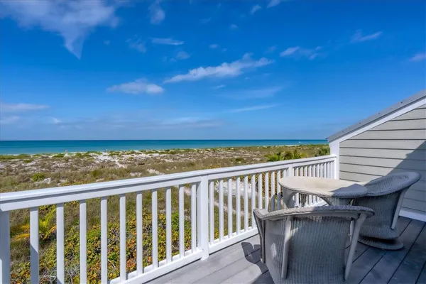 a view of a balcony with wooden floor and fence