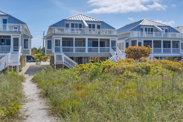 a front view of a house with a yard and balcony