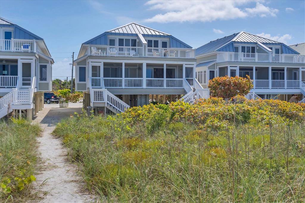 480 Gulf Boulevard, Unit 6 Boca Grande, FL 33921 - Photo 44 of 49 a front view of a house with a yard and balcony
