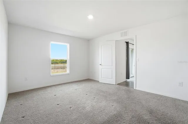 an empty room with windows and closet