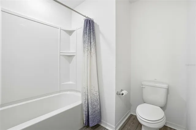 a bathroom with a toilet and a bathtub