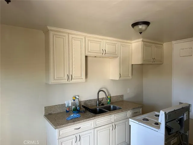 a kitchen with a sink cabinets and appliances