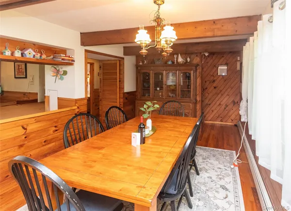 a dining room with furniture and chandelier
