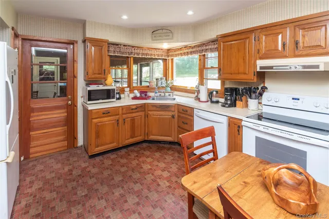 a kitchen with stainless steel appliances granite countertop a sink and cabinets
