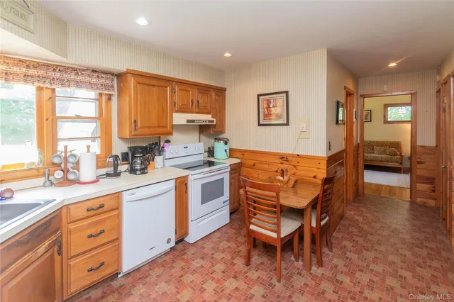 a kitchen with a chair a table and chairs in it