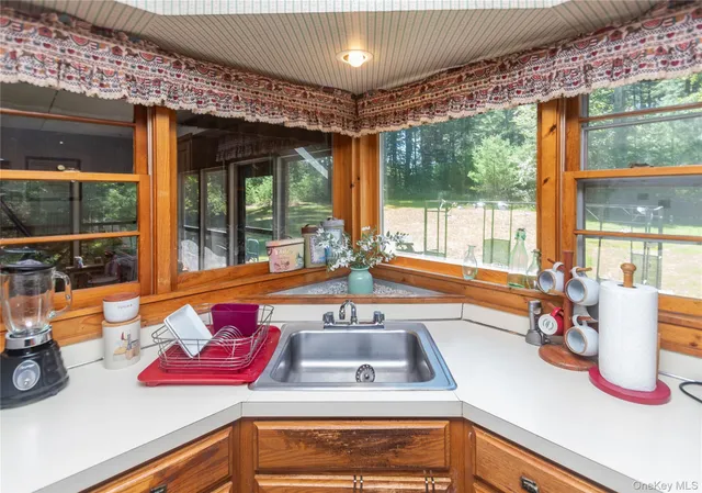 a kitchen with sink and large window