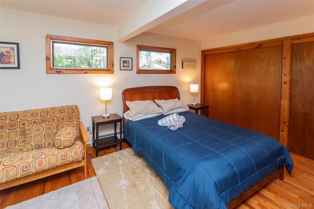 a bed sitting in a bedroom next to a window