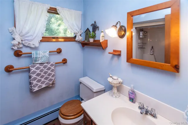 a bathroom with a sink mirror and toilet