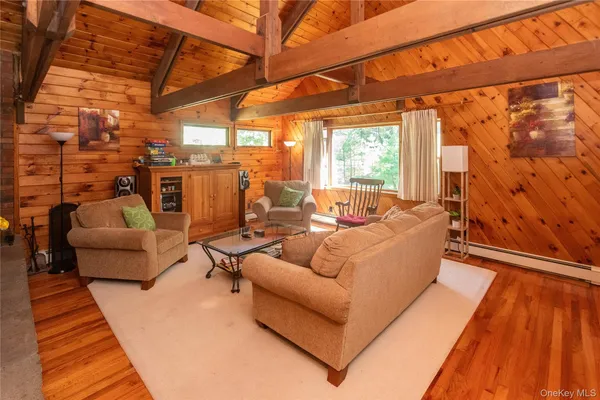 a living room with patio furniture and a wooden floor