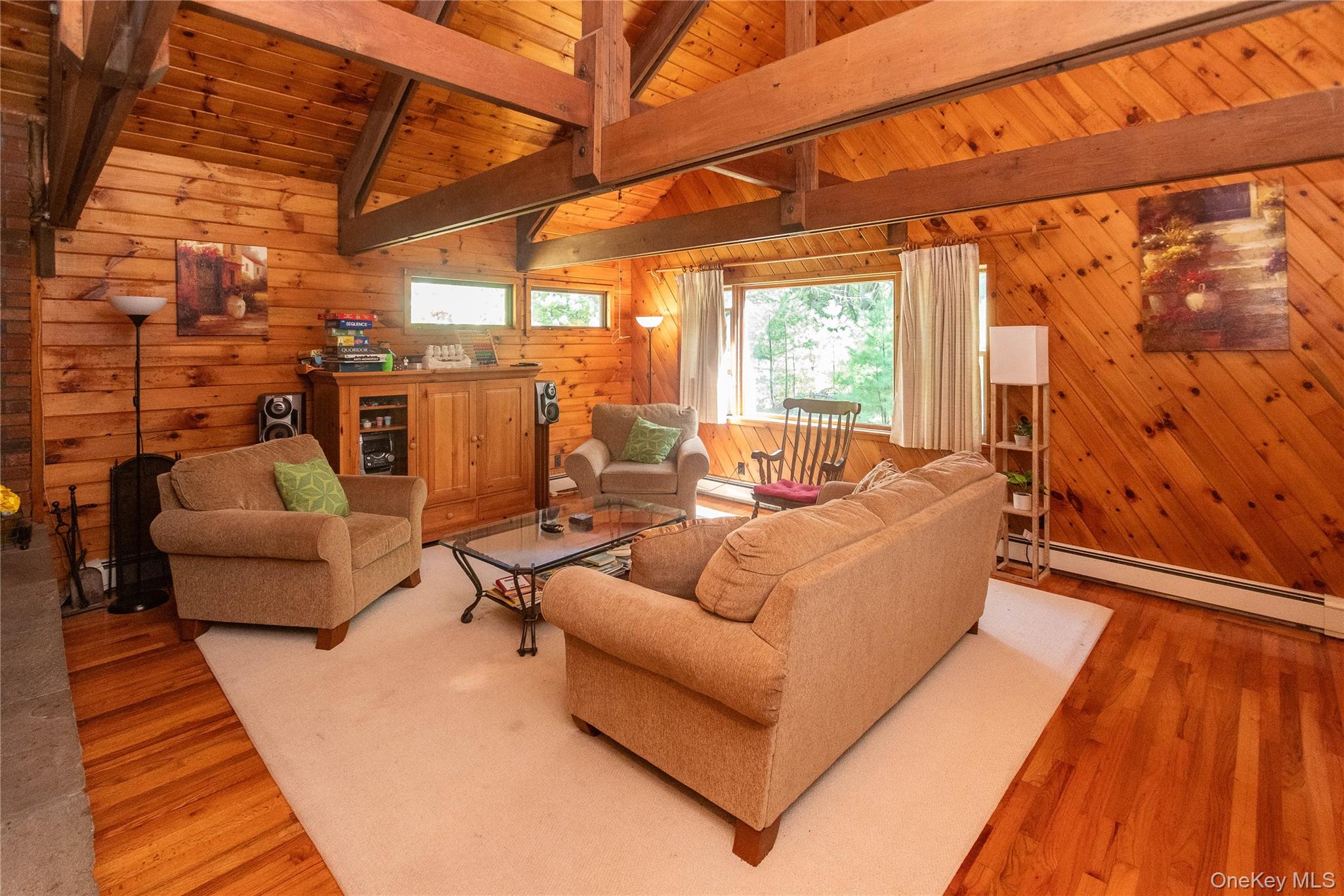 90 Hillside Road Barryville, NY 12719 - Photo 6 of 39 a living room with patio furniture and a wooden floor