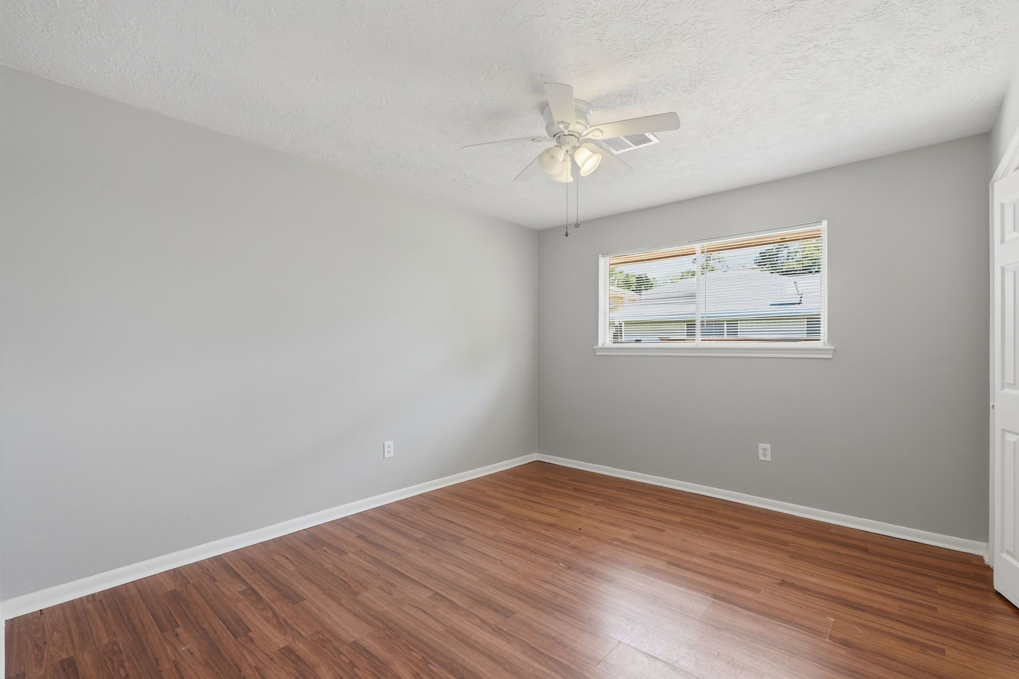 25611 Timberlane Drive Spring, TX 77386 - Photo 28 of 38 a view of an empty room with wooden floor and a window