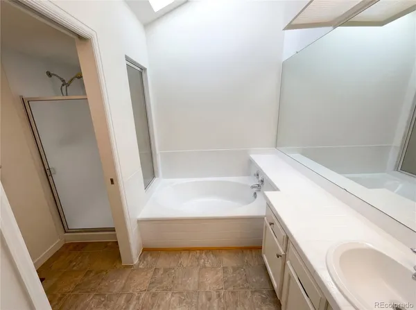 a bathroom with a tub a sink and a toilet
