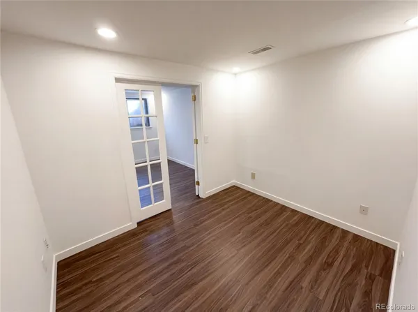 a view of wooden floor and windows in a room