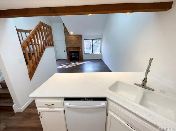 a view of living room with furniture and a fireplace