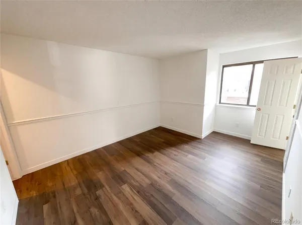 an empty room with wooden floor
