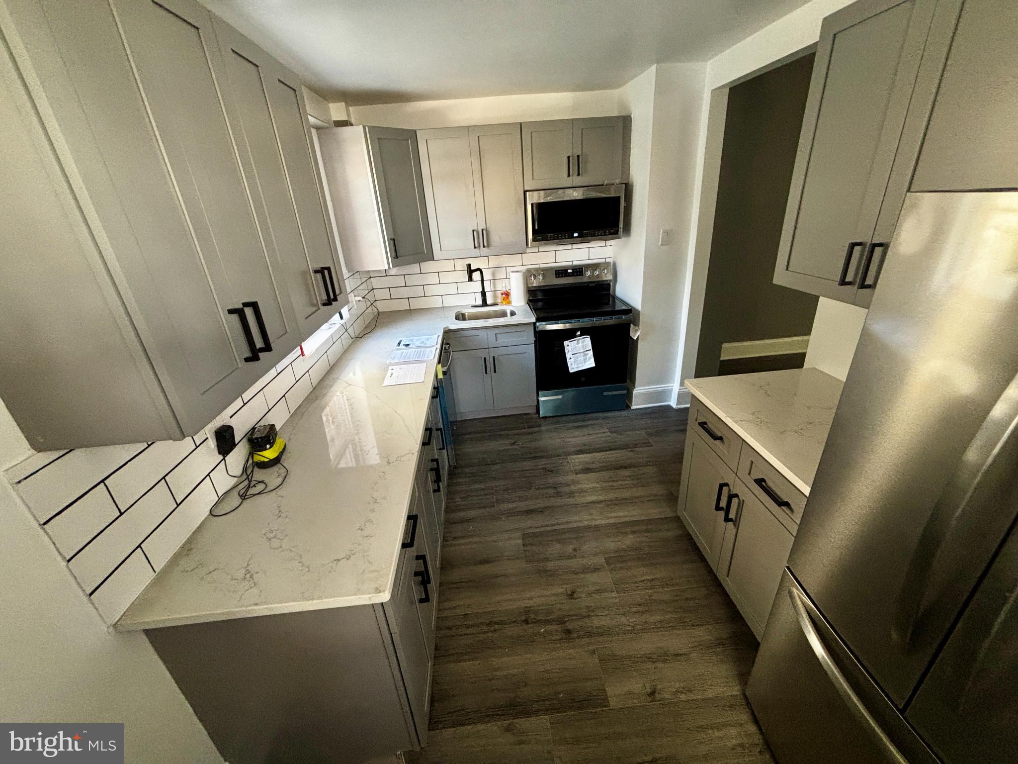 901 South 60th Street Philadelphia, PA 19143 - Photo 13 of 20 a living room with furniture and a flat screen tv