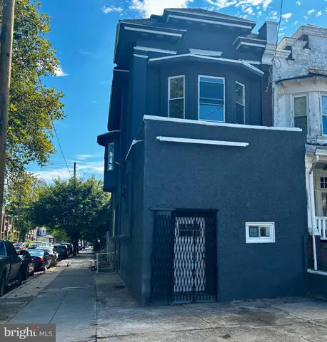 a front view of a building with plants