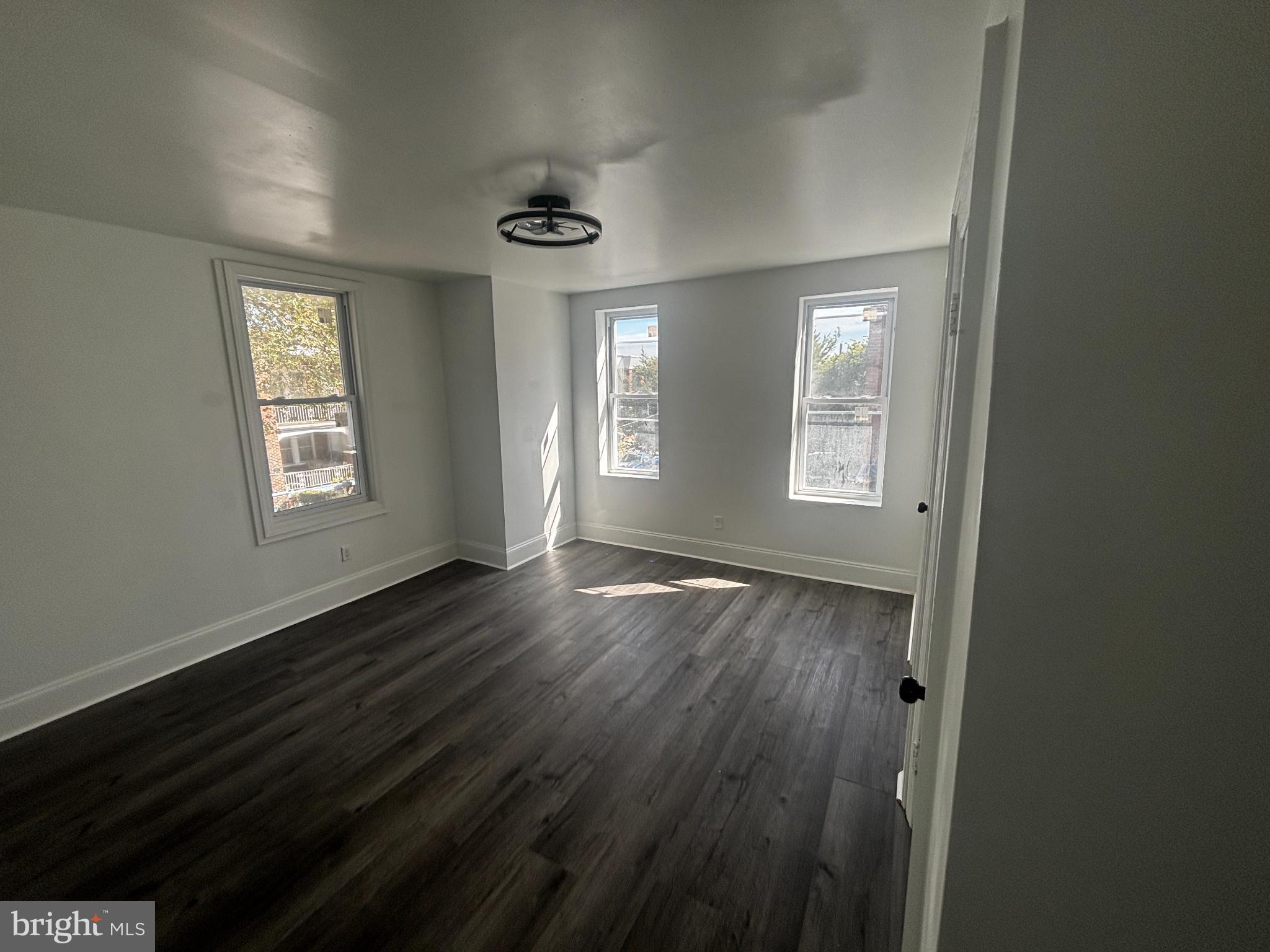 901 South 60th Street Philadelphia, PA 19143 - Photo 7 of 20 a view of an empty room with wooden floor and a window