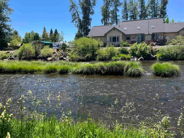 a view of a garden with a house