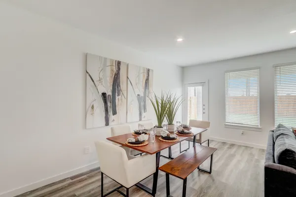 a view of a dining room with furniture and a potted plant