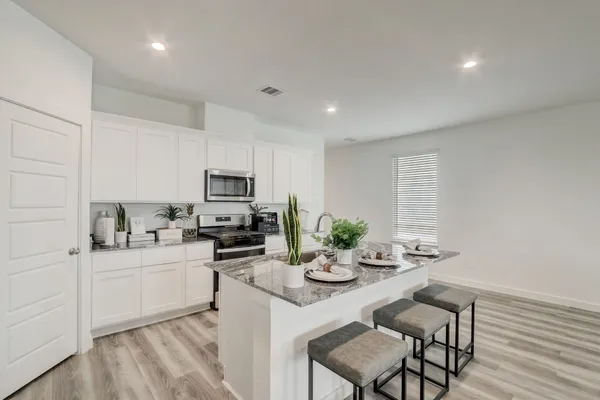 a kitchen with sink cabinets and microwave