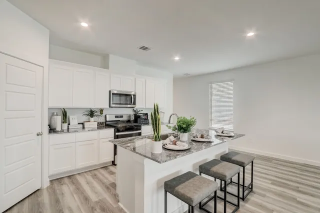 a kitchen with sink cabinets and microwave
