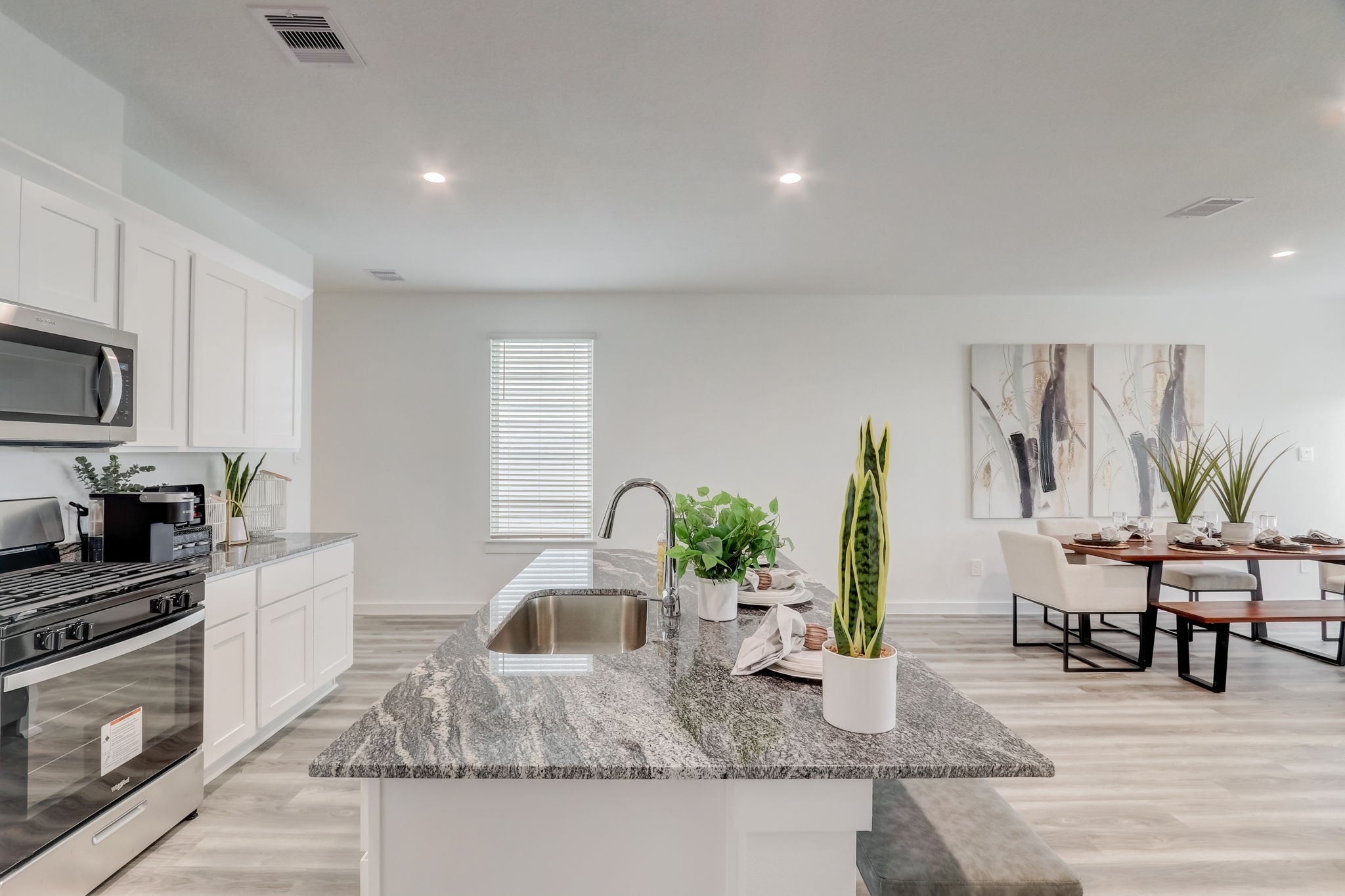2631 Callahan Springs Lane Houston, TX 77051 - Photo 18 of 50 a kitchen with granite countertop a stove a sink a dining table and chairs